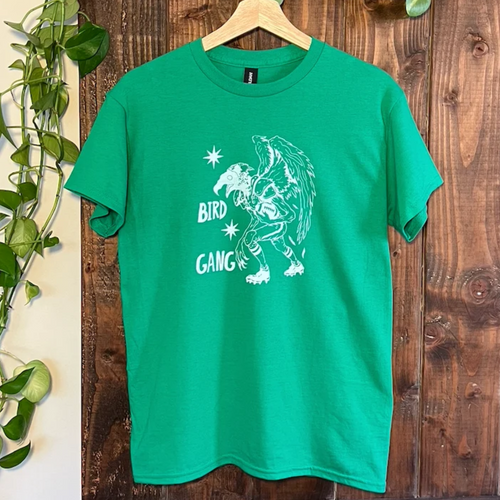 Bird Gang tee in green featuring Bernard, a cryptid eagle in football gear, from Cryptid Records
