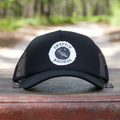 The Beacon (Antenna) curved brim trucker hat displayed on Cryptid treasure chest