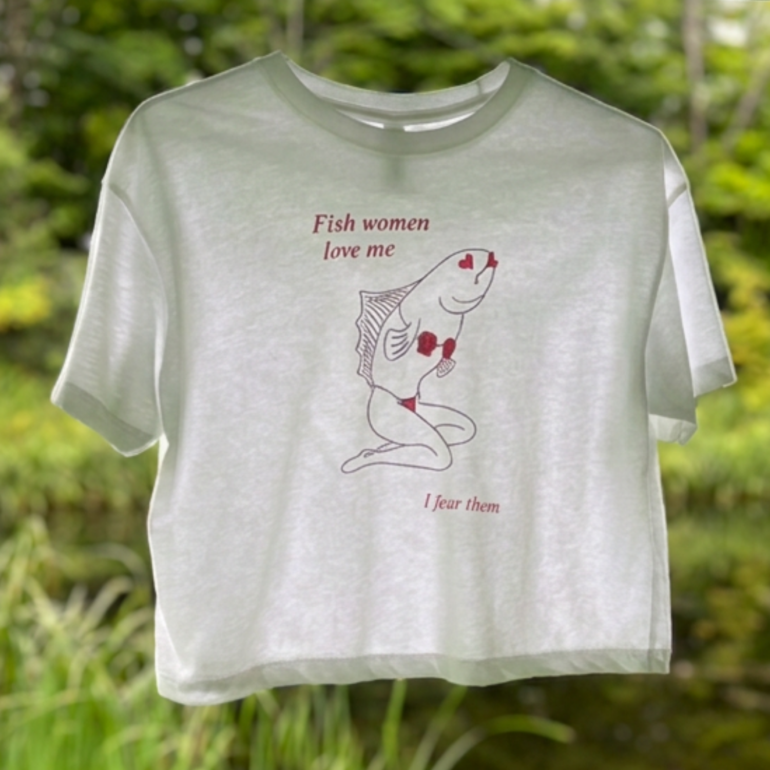 Sirena Fish Woman crop top in white, front view against pond greenery