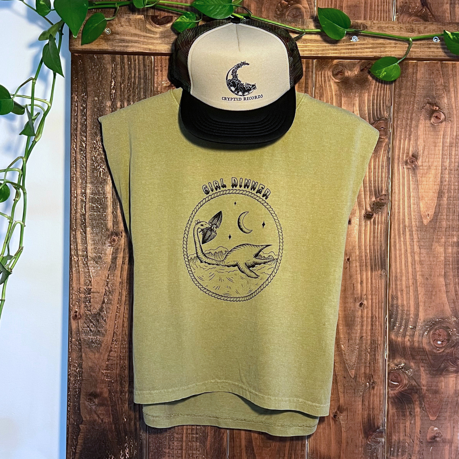 Plesia Girl Dinner muscle tank hanging with a Gizmo raccoon trucker hat