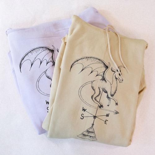 Batsto (Jersey Devil) hoodies folded in light pink and yellow, showing the screen-printed design