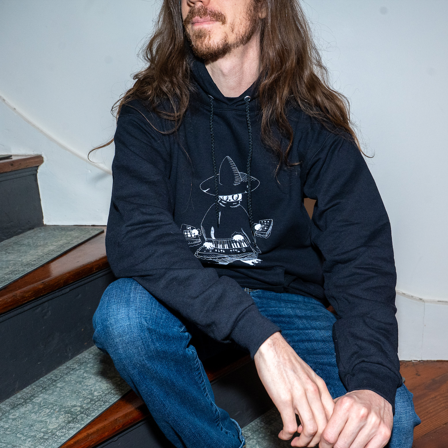 Model wearing Maestro (keys wizard) graphic hoodie from Cryptid Records in black