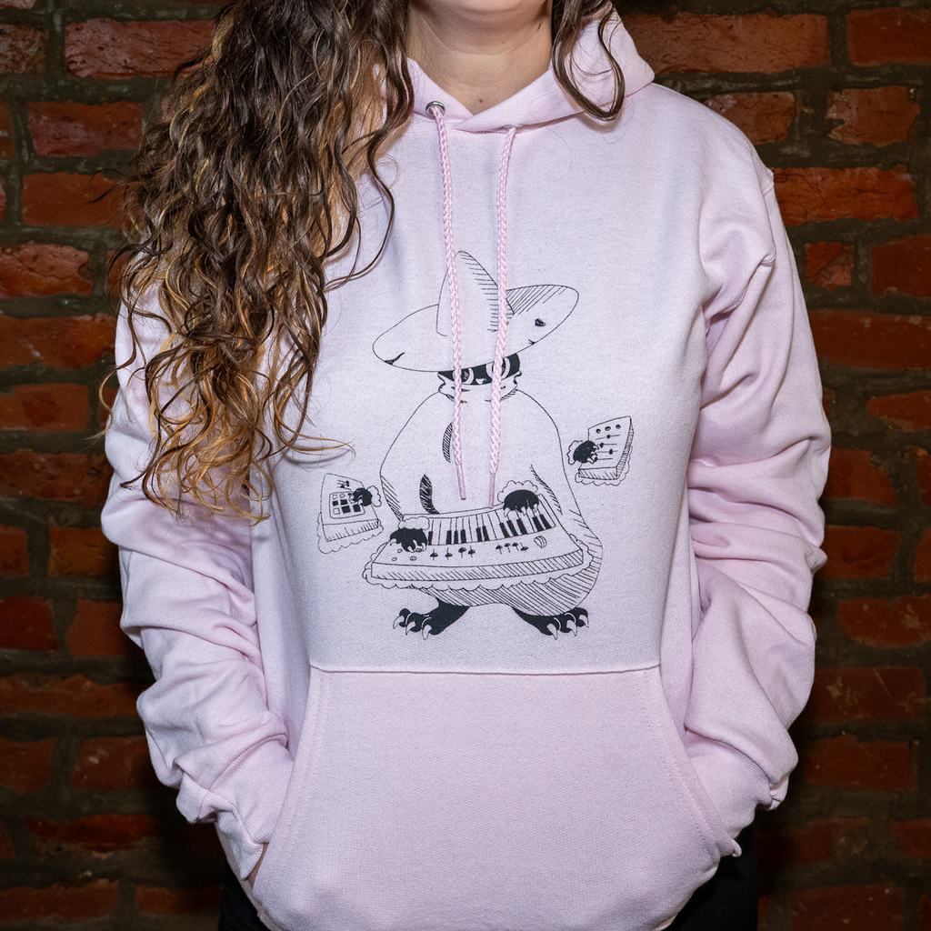 Model wearing Maestro (keys wizard) graphic hoodie from Cryptid Records in light pink