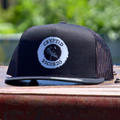 The Beacon (Antenna) snapback trucker hat displayed on Cryptid treasure chest