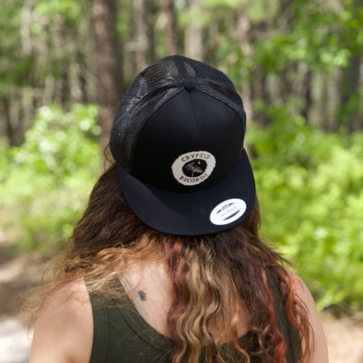 Model wearing The Beacon (Antenna) snapback trucker hat from Cryptid Records